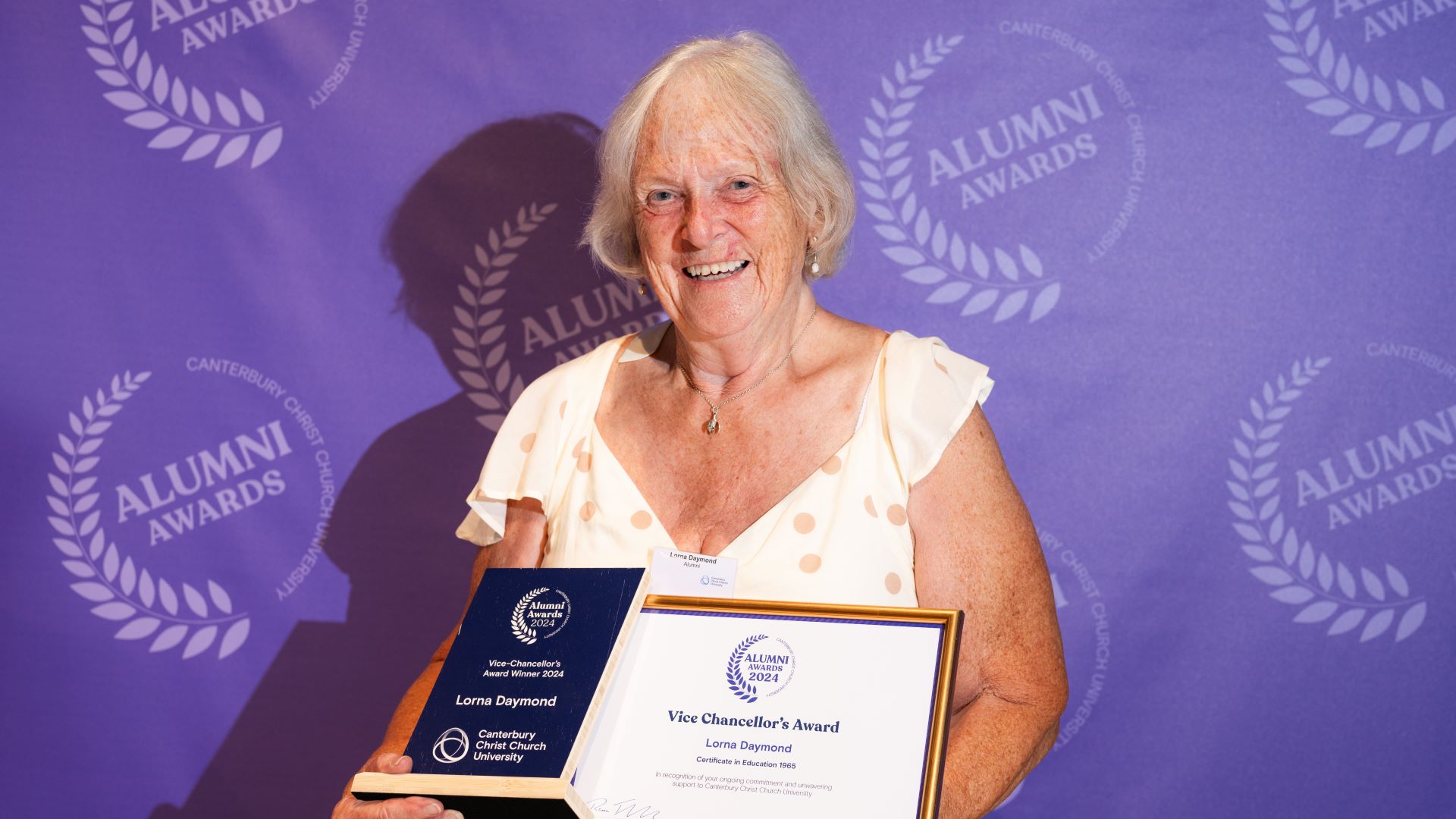 2024 Alumni Vice Chancellor's Award winner, Lorna Daymond, posing with her trophy and certificate