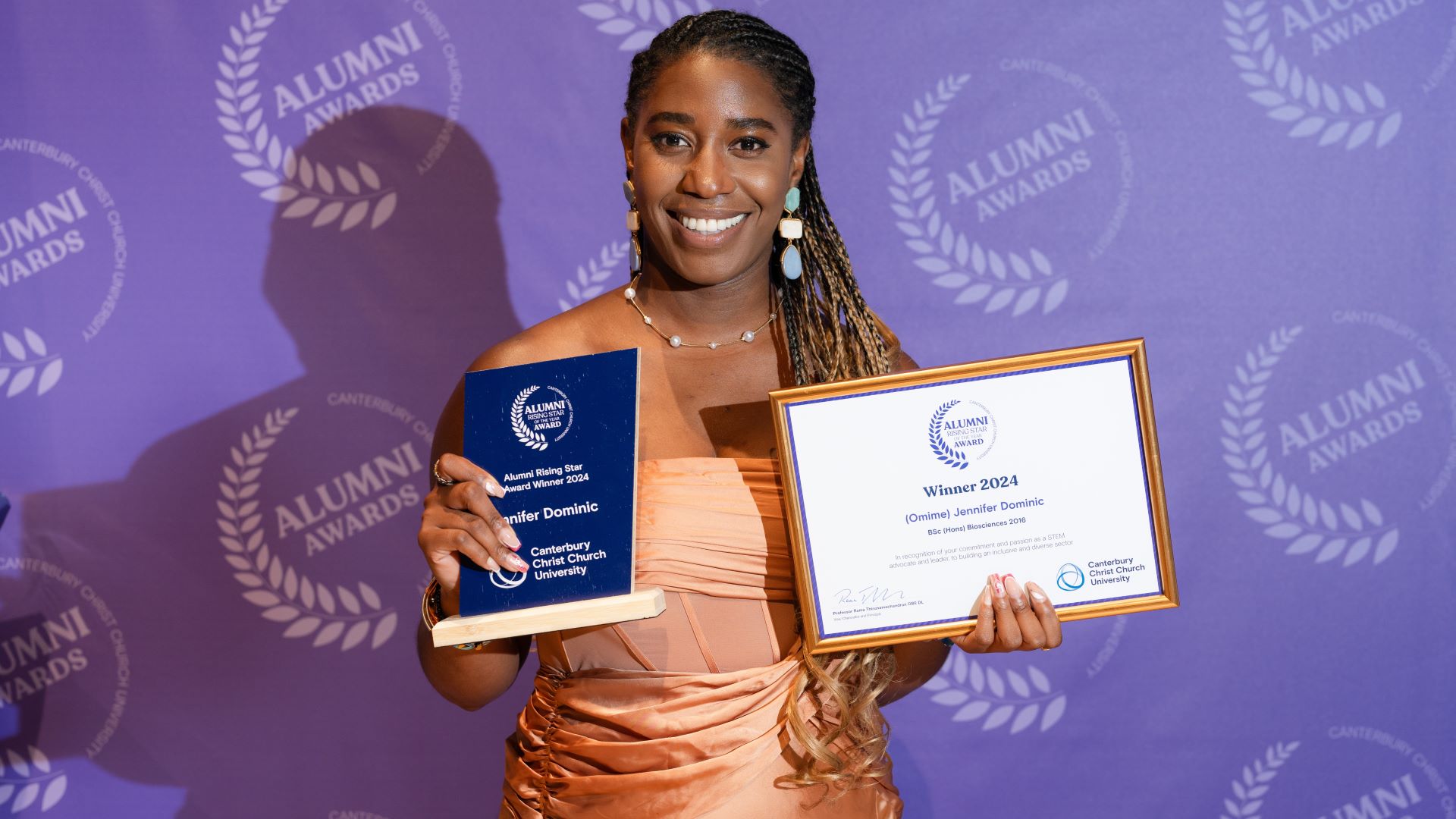 Alumni Rising Star of the Year, Jennifer Dominic, poses with her trophy and certificate