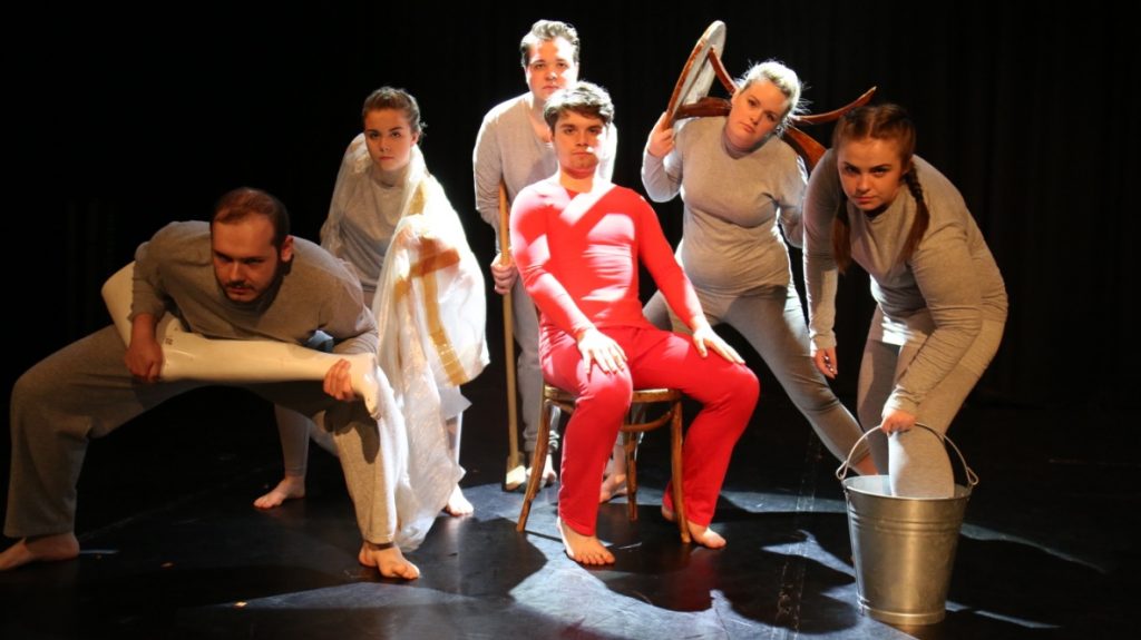 Six drama students pose dramatically with props.