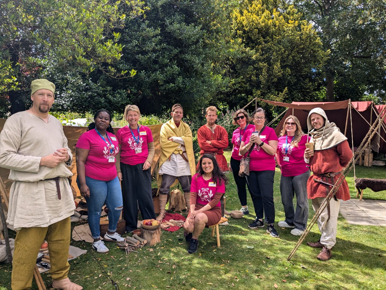 A group of CCCU students and staff posing with medieval reenactors at Canterbury Medieval Pageant 2024.