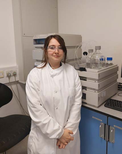 Student standing in a science lab.