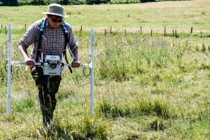 CCCU Archaeology undergraduate Adam Rivett conducting a magnetometry geophysical survey as part of the 2017 CCCU Archaeological Field School