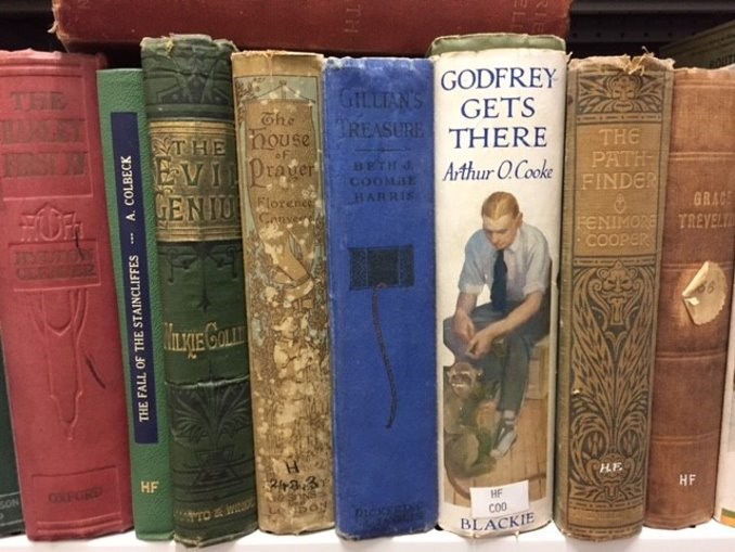 Image shows shelf of children's books from the early to mid twentieth century