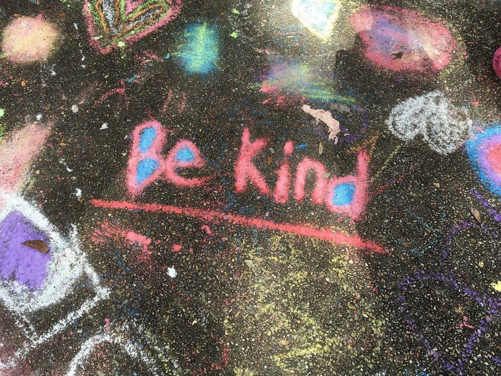 A pavement with be kind written in chalk