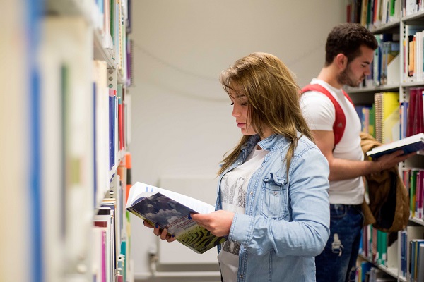 Two students browsing the shelves in Augustine House