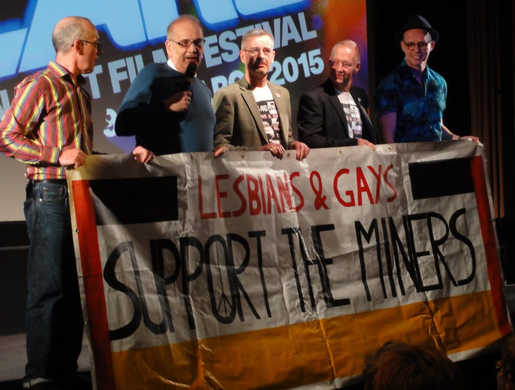 Members of LGSM holding the 1985 LGSM Pride march banner at a film screening of Pride at the BFI. 