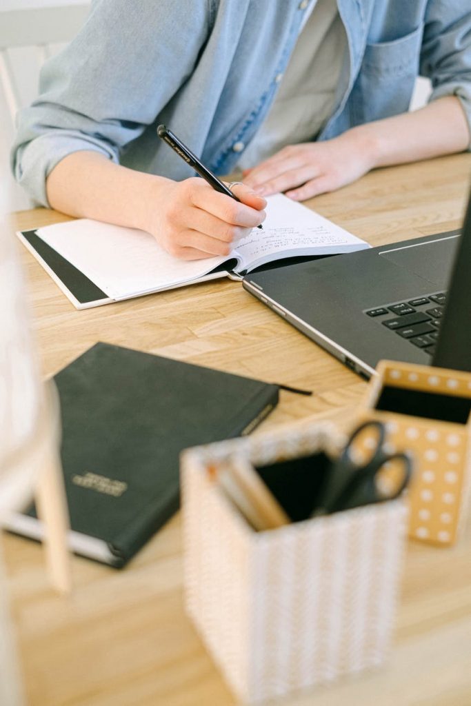 student writing in a notebook