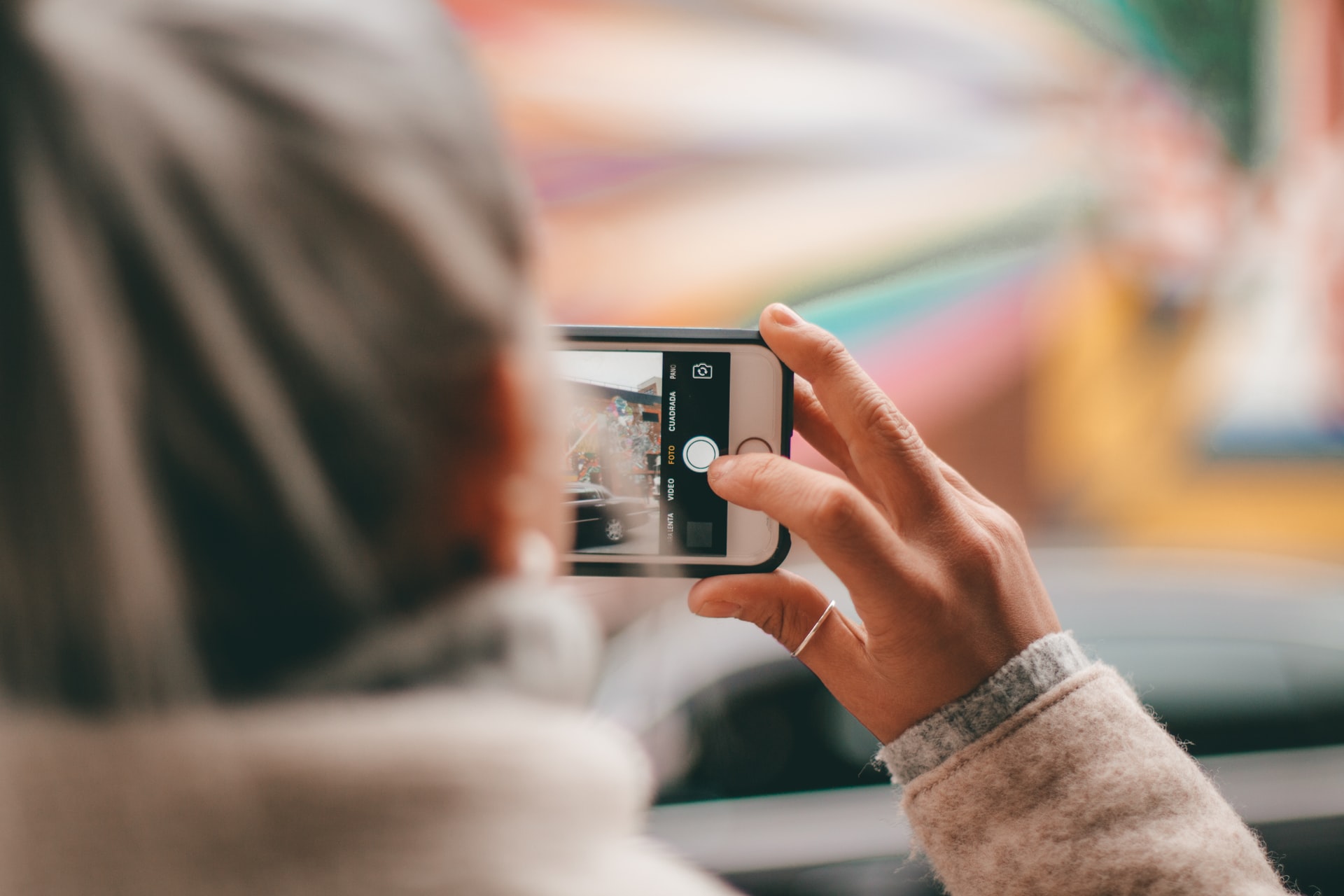 a female taking a photo on their mobile phone