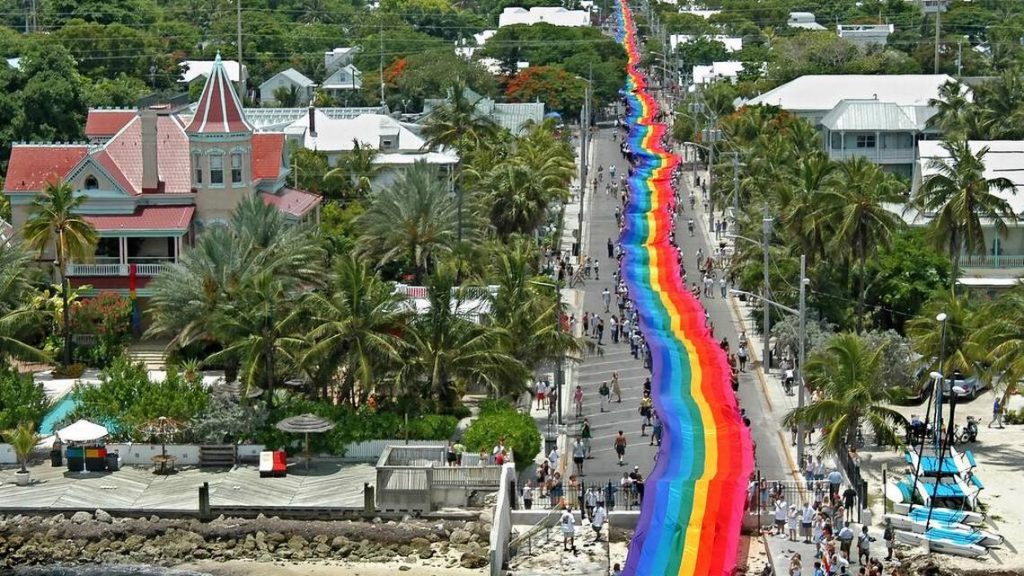 hundreds of people holding the mile long rainbow flag in Florida