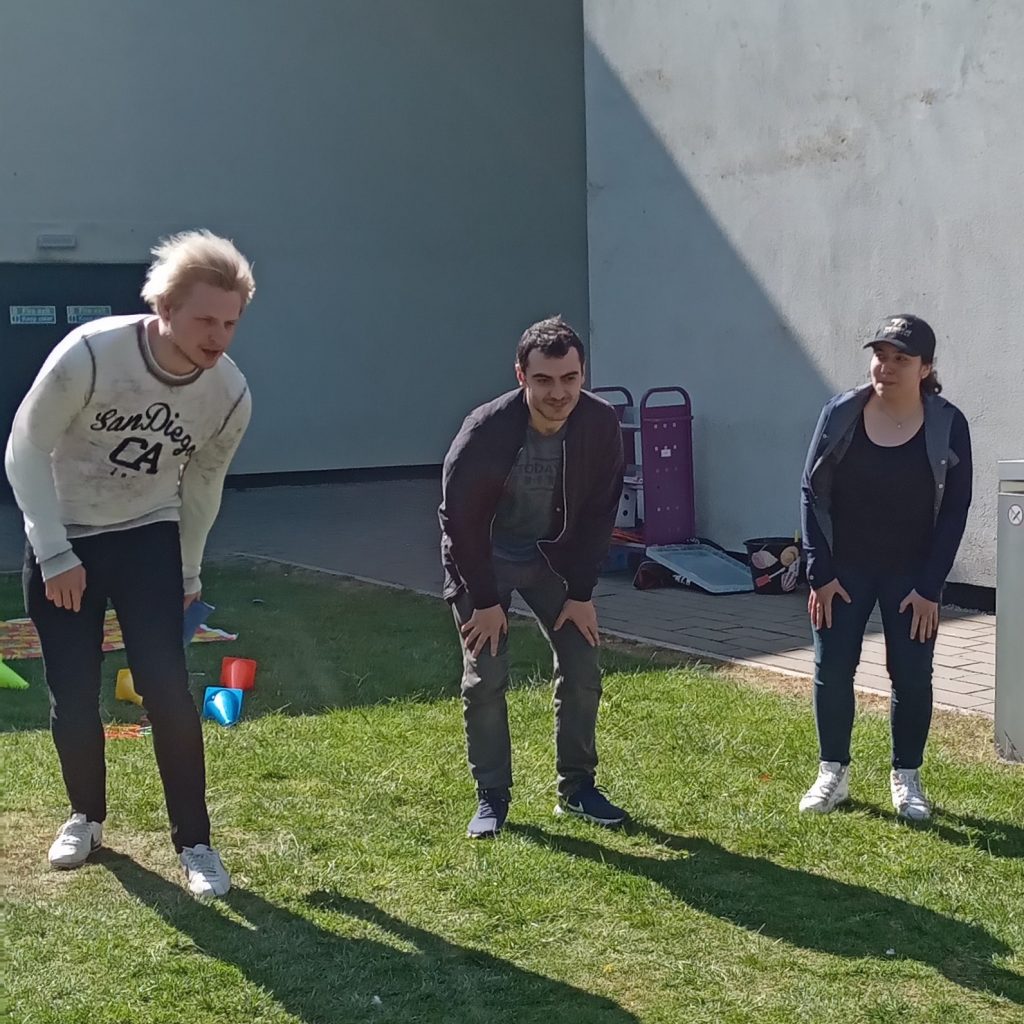 student playing been bag toss