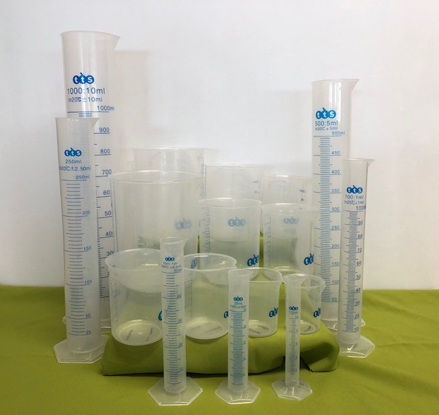 seven beakers, seven cylinders and three jugs all made from plastic of various sizes