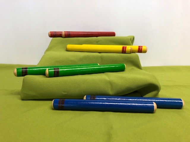Four pairs of wooden claves; each pair differentiated by a different colour.