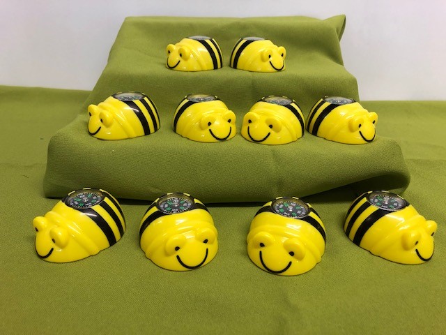 Set of ten plastic bumble bee units with small compasses on their backs.
