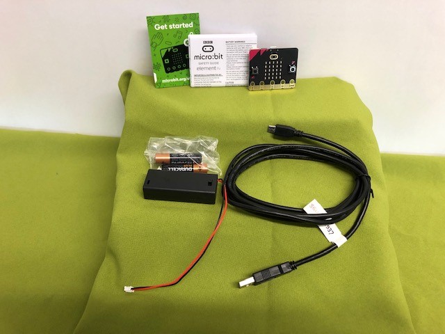 Microbit leaflets, board, battery charger and wires.