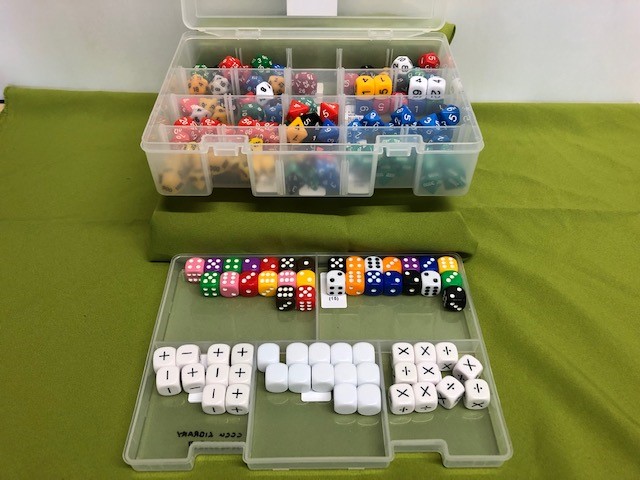 plastic case and pull out containing a large assortment of dice displaying different sides and styles