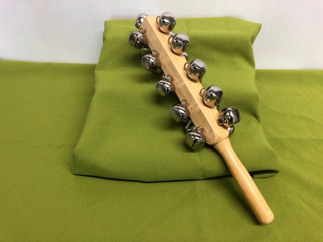 Wooden stick with four sets of five metal bells fixed to one end