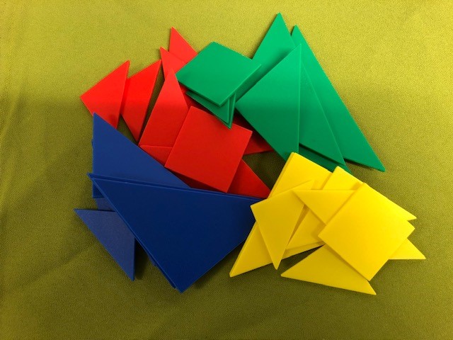 An assortment of tangram shapes including triangles and squares in four different colours