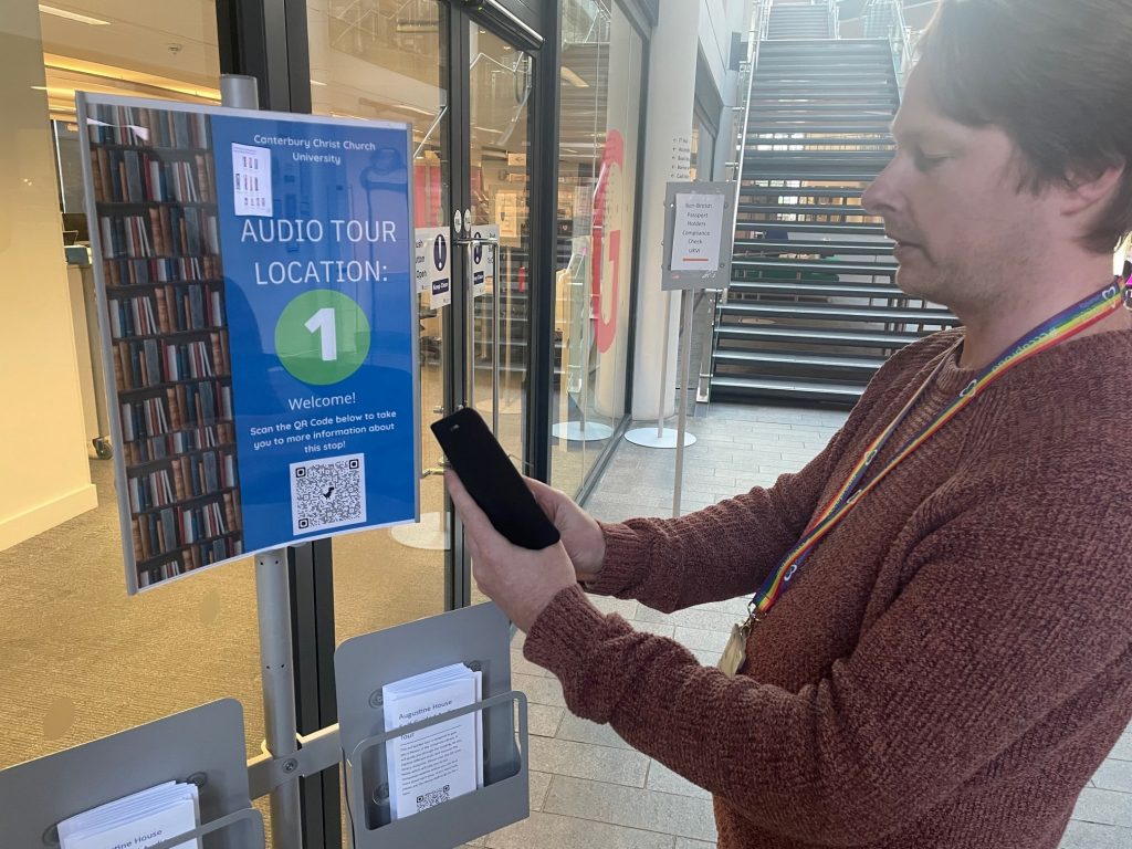 Someone scanning a QR code as part of the audio tour.