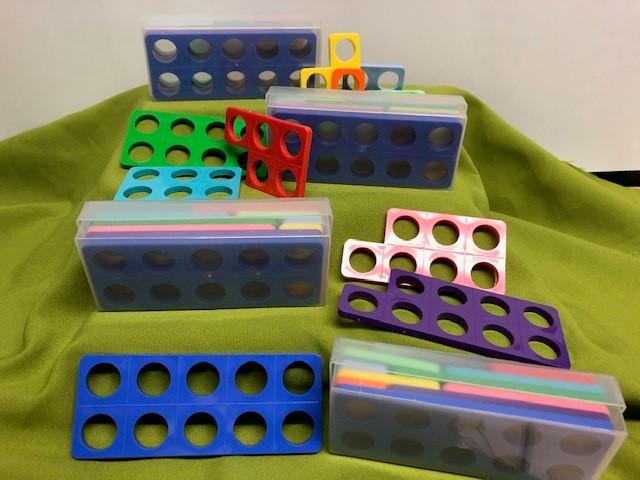 An assortment of plastic numicon shapes depicting different values