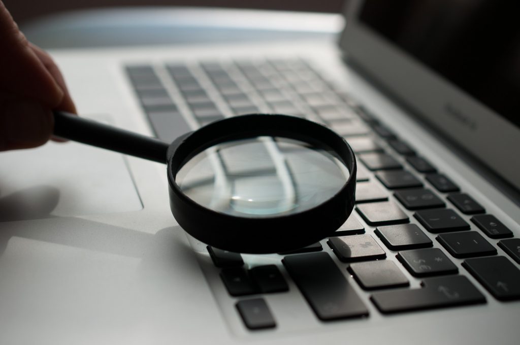 Magnifying glass on laptop. Photo by Agence Olloweb on Unsplash