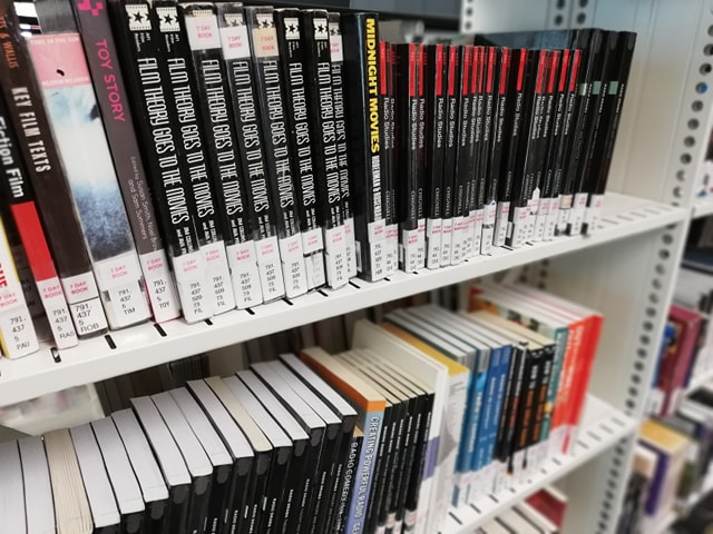 A photograph of two rows of library shelves holding Film Studies books.
