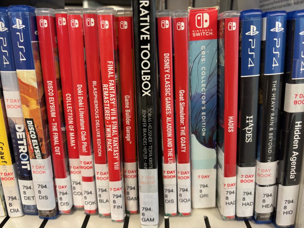 A shelf of Nintendo and Playstation video games.