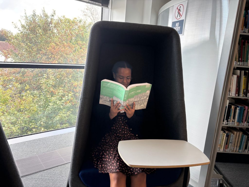 Student reading book in a new comfortable chair.