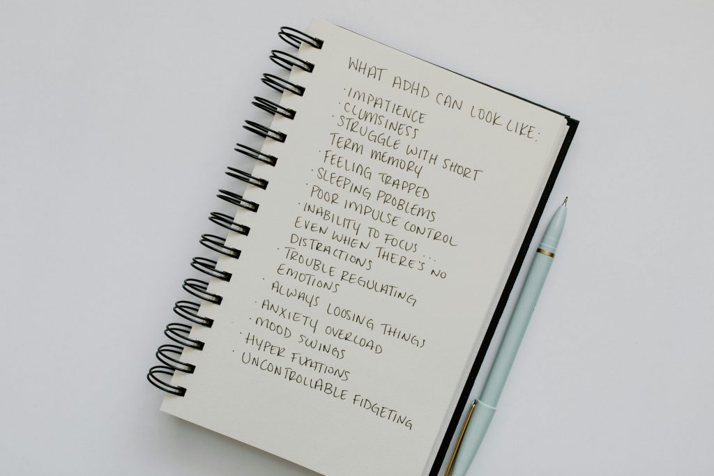 A List of ADHD Disorder Signs Written on a Notebook.
