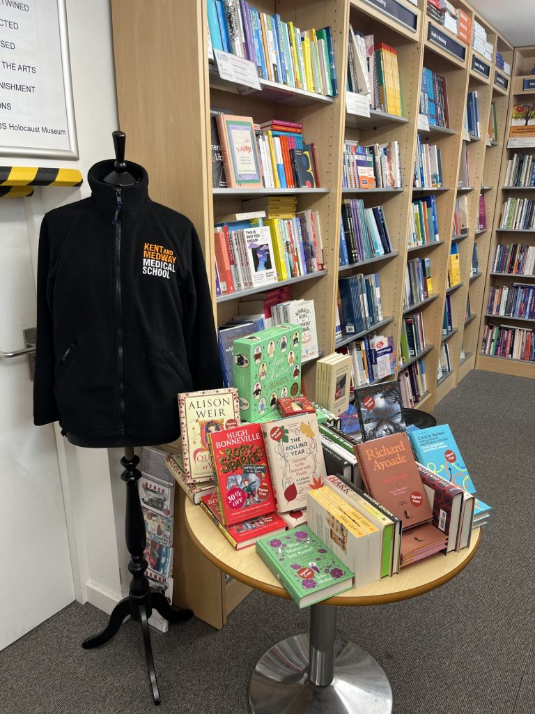 Image of Kent and Medway medical school fleece and table of books.