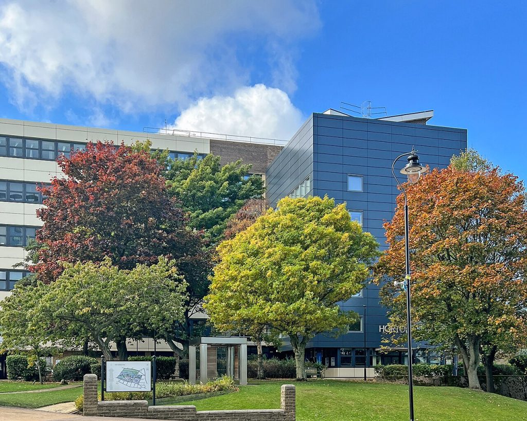 A building at the University of Bradford, behind some trees.