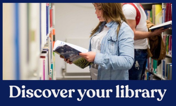 Student looking through the bookshelves in the library