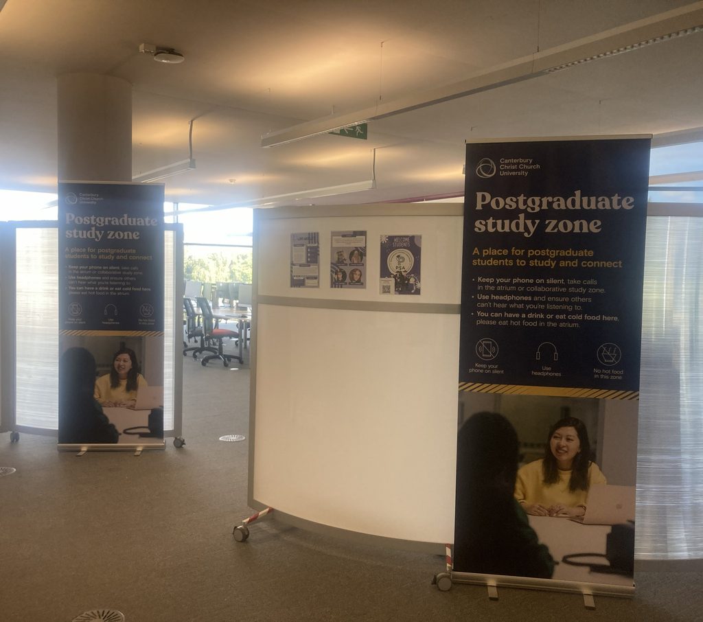 Two new large standing banners outside the entrance of the new Postgraduate Study Area, now enclosed with wall dividers.