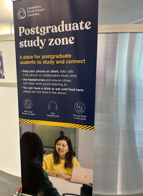 Roll out sign of a Postgrad sign located outside Postgrad area on second floor.