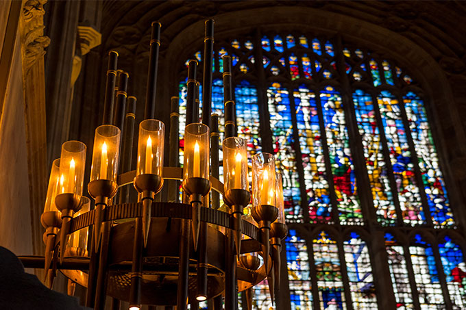 Candles and stained glass window of King's College Cambridge