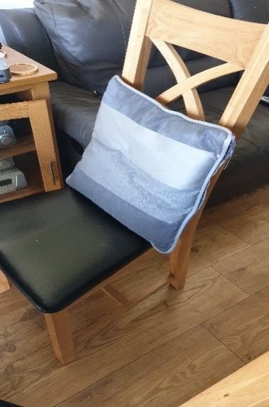 Cushion on chair to provide lumbar support