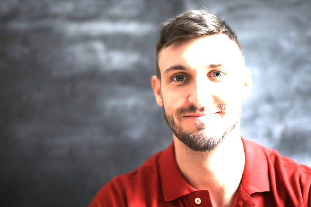 Man smiling at the camera. This image shows what over exposure looks like.