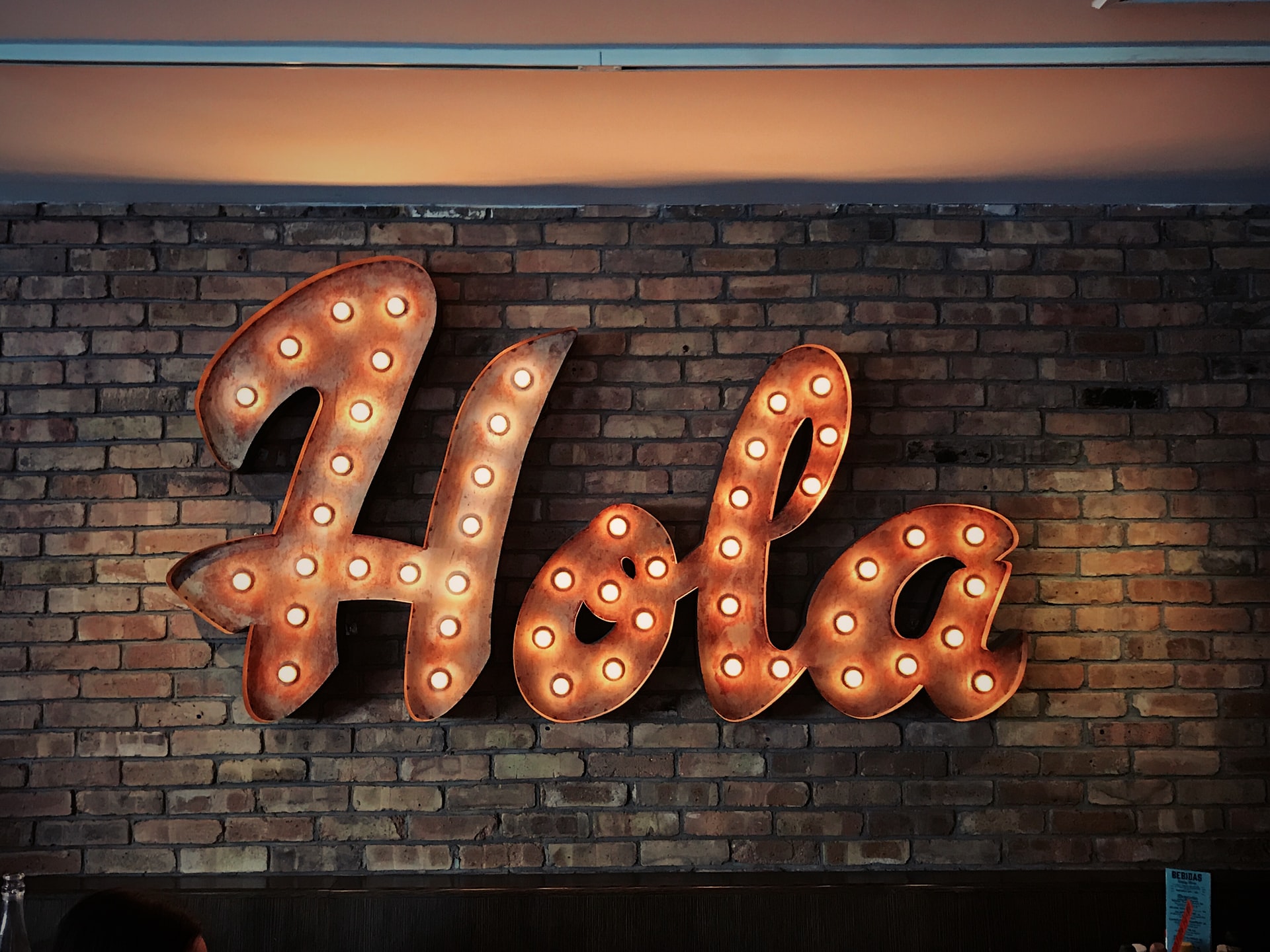 sign in lights which says Hola