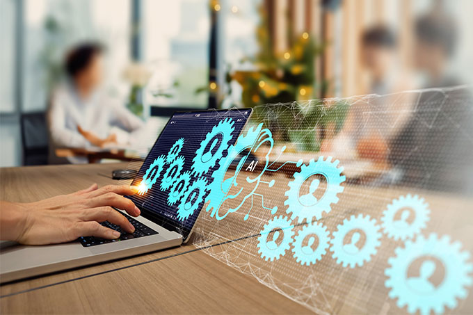 Someone in an office typing on a laptop