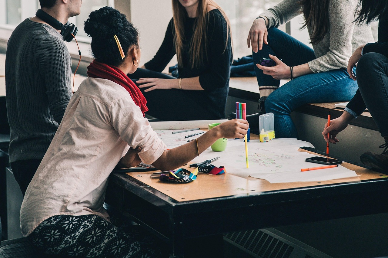 Group of people studying around a desk